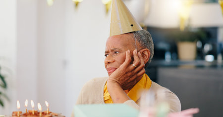 Thinking, birthday and sad senior woman with depression, grief and lonely in her home. Cake, face...