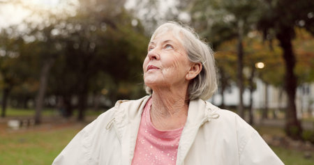 Senior woman, thinking and outdoor at the park to breathe fresh air in nature or woods on walk in...