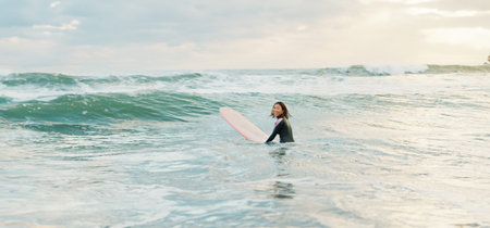Surfing, beach and woman with waves on surfboard for water sports, fitness and freedom by ocean....