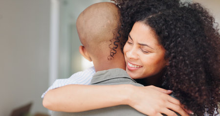 Home, hug and couple with love, marriage and smile with relationship, care and bonding together. Apartment, man and woman with trust, happiness and vacation with commitment, cheerful and joyfulの写真素材