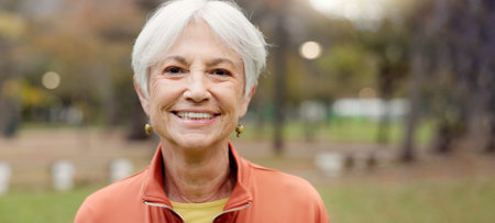 Senior woman with a smile, portrait in the park and happiness in nature, woods or outdoor for a walk...