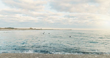 Ocean, sports and people surfing at beach on blue sky for fitness, health or recreation in summer....