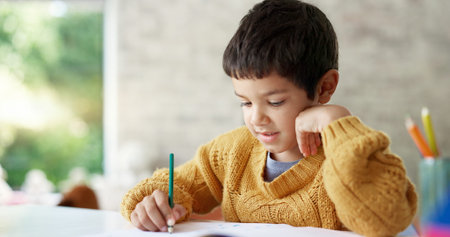 Child, drawing or boy writing homework on notebook in kindergarten education for growth development....