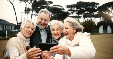Senior people, happy or friends take a selfie in park together for a memory with smile or joy outdoors. Group, old man or elderly women taking photo or picture in nature for social media for vloggingの写真素材