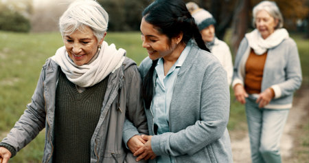 Happy, walking and a woman and caregiver in nature for talking, support and relax in the morning....