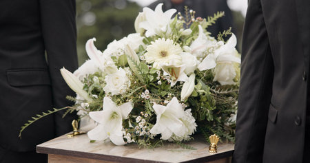 Carrying coffin, flowers and people at funeral for service, mourning and at the graveyard. Closeup,...