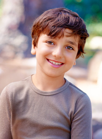 Boy, child and portrait for relaxing outside, smile and happy on outdoor adventure in nature. Male...