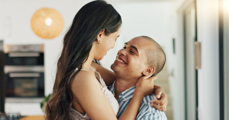 Couple, hug and kissing for love at home, happy and support in marriage and embrace for romance. People, spin and bonding together for relationship, lovers and commitment or loyalty in apartmentの写真素材