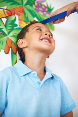Smile, kid and hands measure height, check future increase in growth of boy and track length in home...