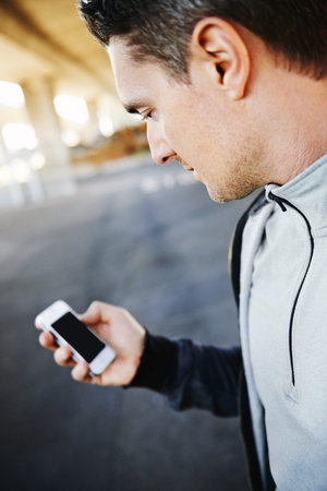 Man, runner and checking progress on phone, screen and exercise or training for marathon. Male...