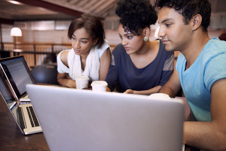 University, education and students in library on laptop for research, studying and learning on...
