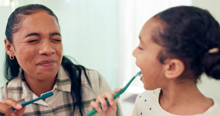 Smile, brushing teeth and mother with daughter, morning routine and child development in bathroom....