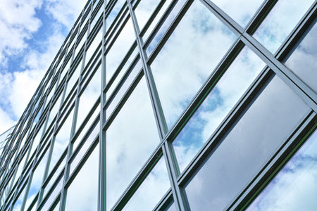 Low angle, construction and building with glass windows in city for business, office and commercial...