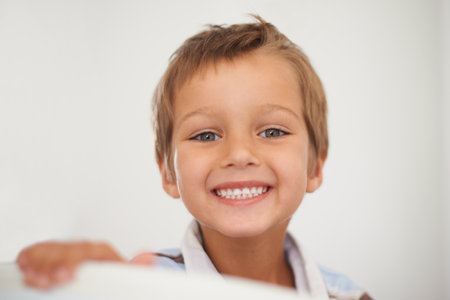 Portrait, happy and healthy boy for dental care in home, oral hygiene and growth or development of milk teeth. Child, strong and face for white smile or clean mouth and good habits for fresh breathの写真素材