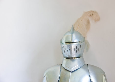 Knight, medieval suit and armor with mockup space of soldier, statue or honor on a gray studio background. Helmet, gear or equipment for battle, war or security in justice, shining silver or visorの写真素材