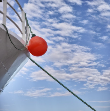 Buoy, ship and travel with transportation and blue sky, nature and fresh air, vacation or journey on cruise with safety for sailing. Boat, yacht for sea voyage or adventure, luxury and life preserverの写真素材
