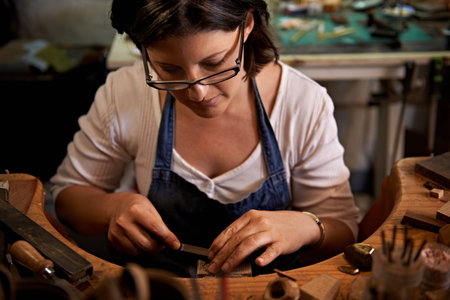 Carving, wood and artist with tools in workshop for creative project or production of sculpture on...