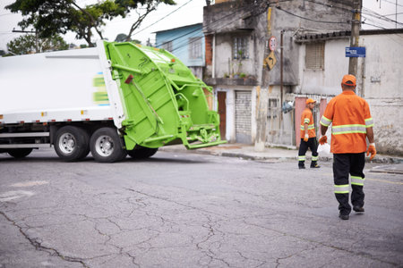 Teamwork, truck and garbage collection for cleaning and disposal in waste management or trash. Dumpster refuse, cleanup by sanitation workers for rubbish removal and environmental sustainabilityの写真素材