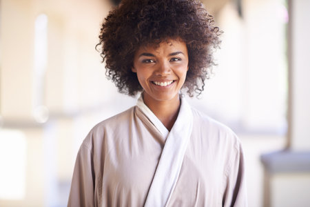 Woman, smile and portrait in spa for skincare, beauty and cosmetic treatment for break or relax. African person and happy for holistic and wellness care for hygiene, clean and natural in robeの写真素材