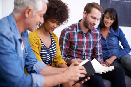 Employees, collaboration and CEO smile for book, guide and happiness for team in workplace. Brainstorming, men and women in interior decoration business, discuss and plan for project in officeの写真素材