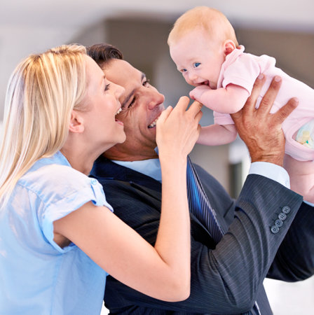 Family, happy and parents with baby in living room for bonding, affection and childcare at home. Infant, smile and cheerful for interaction with mother, father and healthy relationship in houseの写真素材