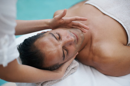 Spa, man and hands with massage for relax at resort, luxury hotel and vacation for wellness and therapeutic pamper. People, masseuse and body care with facial treatment, hospitality and zen outdoorの写真素材