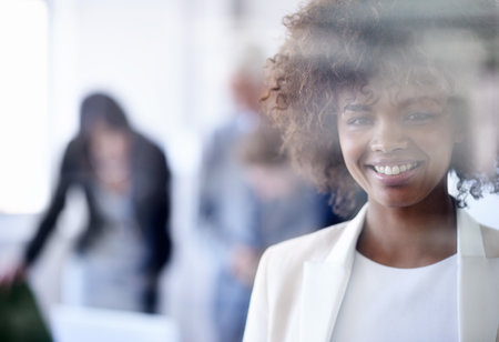 Smile, window and portrait of woman in office for corporate job, seminar and business meeting. African girl, entrepreneur and pride with confidence for startup, career and conference in workplaceの写真素材