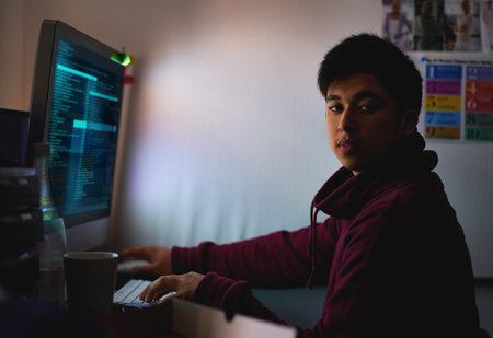 Night, portrait and man with computer for coding systems or designing software, cybersecurity and developer for company. Male person, programming or cloud engineer and malware with display of scriptの写真素材