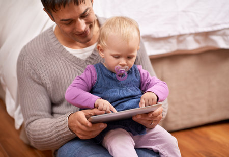 Tablet, search or father and baby on a floor for cartoon, streaming or gaming while bonding at home. Digital, learning or dad and girl in bedroom with storytelling app, fantasy or child developmentの写真素材