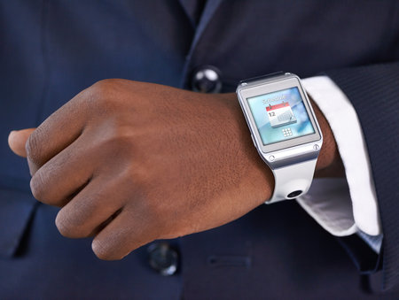 Businessman, hand and smart watch on wrist for digital agenda, online schedule and high tech for job. Black man, arm and suit with future technology for network, screen and check time at workの写真素材