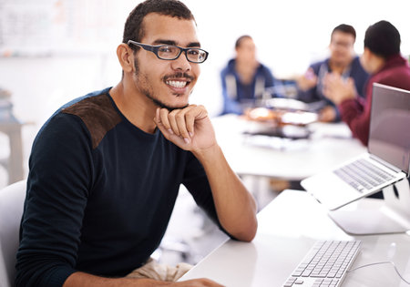 Young man, computer and portrait in workspace for web development, programming or information...