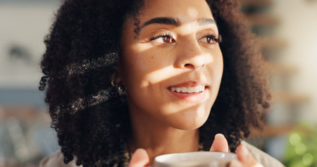 Smile, calm and woman with coffee by window in apartment for relaxing weekend morning routine. Happy, peace and young female person drinking cappuccino, tea or latte in cup with aroma at modern home.の写真素材
