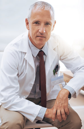 Portrait, senior doctor and serious man in hospital for healthcare, wellness or working in Australia for career. Confidence, medical professional or surgeon, expert or physician in clinic for serviceの写真素材