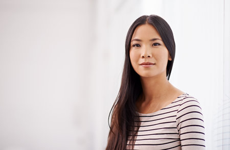 Company, office and portrait of business Asian woman with confidence, pride and ready for opportunity. Creative startup, professional worker and person in workplace for career, job and work in Japanの写真素材