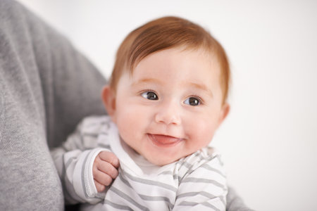 Baby, love and newborn with smile for parent, comfort and bonding with little kid at family home. Infant, person and happy girl in house with support, safety and playful with childhood developmentの写真素材