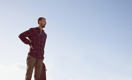 Skateboard, thinking and man at a skate park with idea for trick, stunt or adrenaline sports on blue...