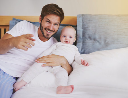 Family, bedroom and portrait of father with baby for bonding, relationship and love for parenting. Happy, home and dad relax with newborn infant for child development, support and care in houseの写真素材