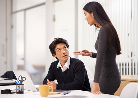 Laptop, problem and mentor in office for discussion with businessman learning from woman. Feedback, advice and training asian man on computer with mistake and error in online research projectの写真素材