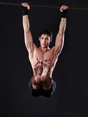 Exercise, pull up and man with fitness, challenge and endurance with progress and cardio training. Muscular, person and athlete with a bar and strength with workout and wellness with body and muscleの写真素材