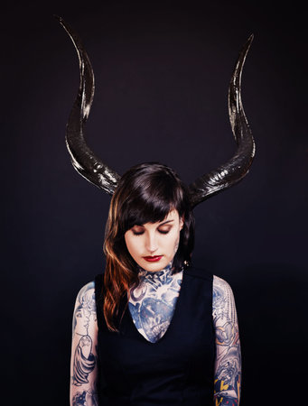 Woman, horns and tattoo for costume, cosplay and creative with ink for design, picture and symbol....