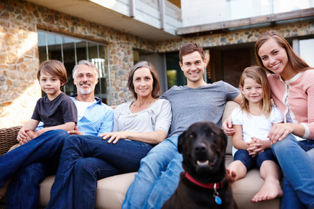 Portrait, smile and family at house with dog outdoor together on sofa for love and bonding at...