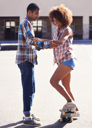 Happy, learning and man with woman on skateboard in city on romantic and fun date together. Smile,...