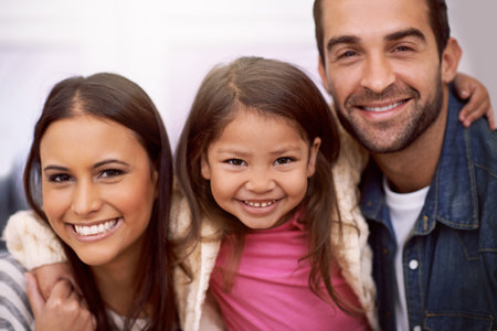 Portrait, family or smile to relax, fun or hug in cheerful, pride or confidence as bonding together. Papa, mama or girl child as happy, rest or embrace on playful, break or vacation as loving leisureの写真素材