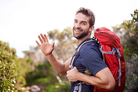 Man, hike and happy with wave for adventure with backpack for fitness, workout and hobby in Canada....