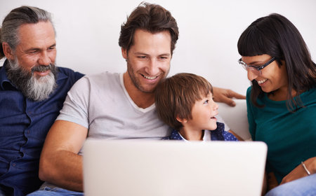 Family, laptop and young boy or streaming on couch, smile and bonding in living room. Video call,...