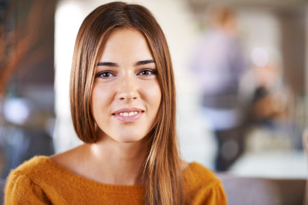 Portrait, smile and home with woman, relax and happiness with weekend break and peace in a living room. Face, apartment and girl with joy and calm with rest and person in a lounge with confidenceの写真素材