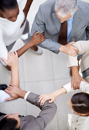 Business people, top view and arm circle in office in support for teamwork, collaboration or...