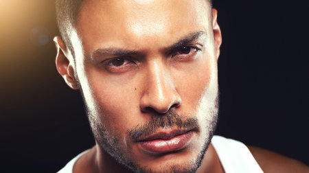 Portrait, exercise and man with fitness, training and exhausted on a dark studio background. Face, confident person and healthy model with wellness and fatigue with breathing or athlete with practiceの写真素材