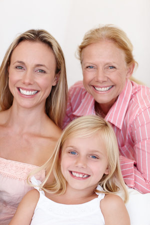 Portrait, parent and young girl with generations at family house by embrace, bonding and love on...