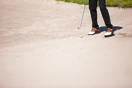 Golf, club and bunker with ball for shot with closeup of legs on pitch for recreational hobby....